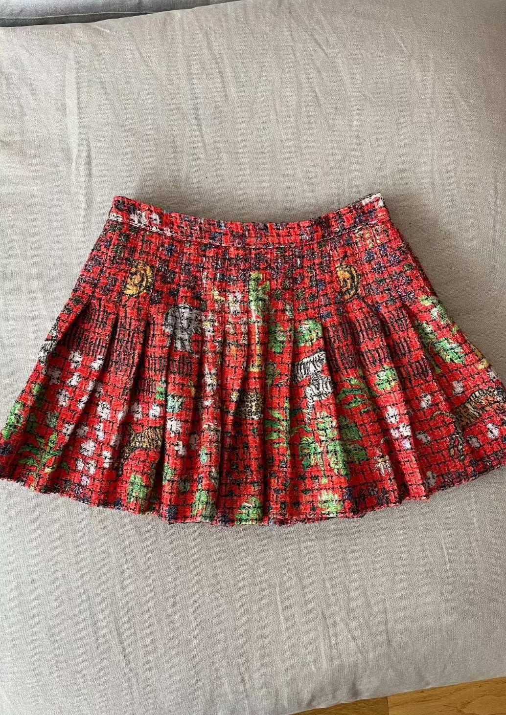 Tweed pleated mini skirt in signature red Fever Dream print, hand-illustrated by designer Olivia Cheng.