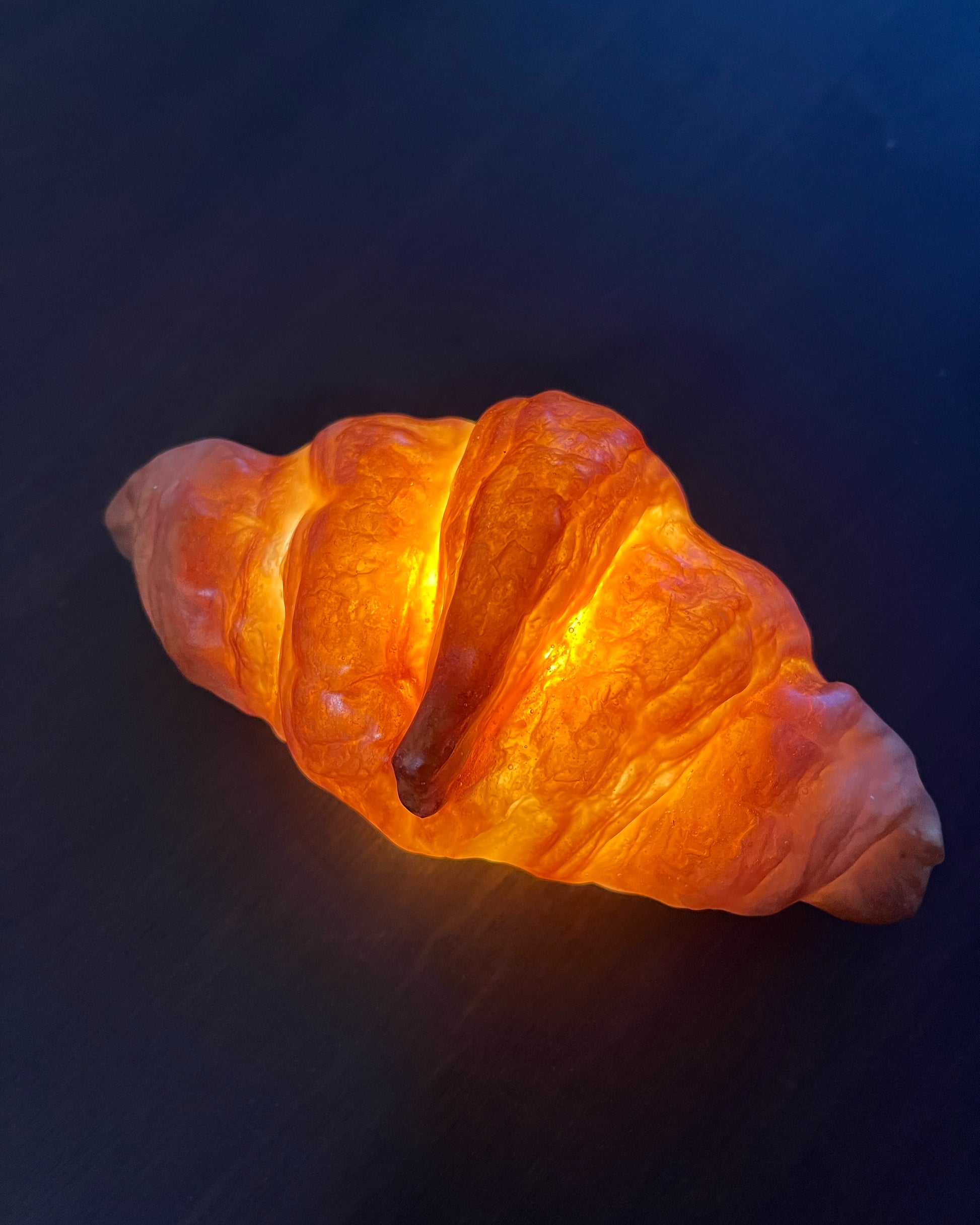 Lit up Eco Resin coated Croissant Lamp on table